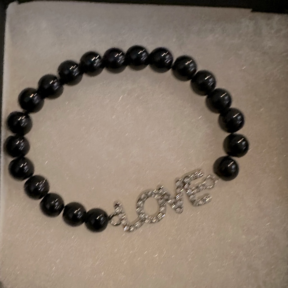 NWOT stretch LOVE bracelet with black beads